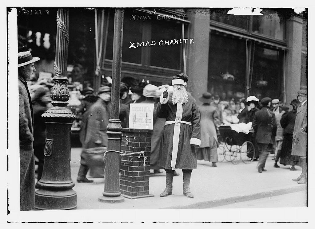 men dressed as santa stood in the streets collecting charity donations
